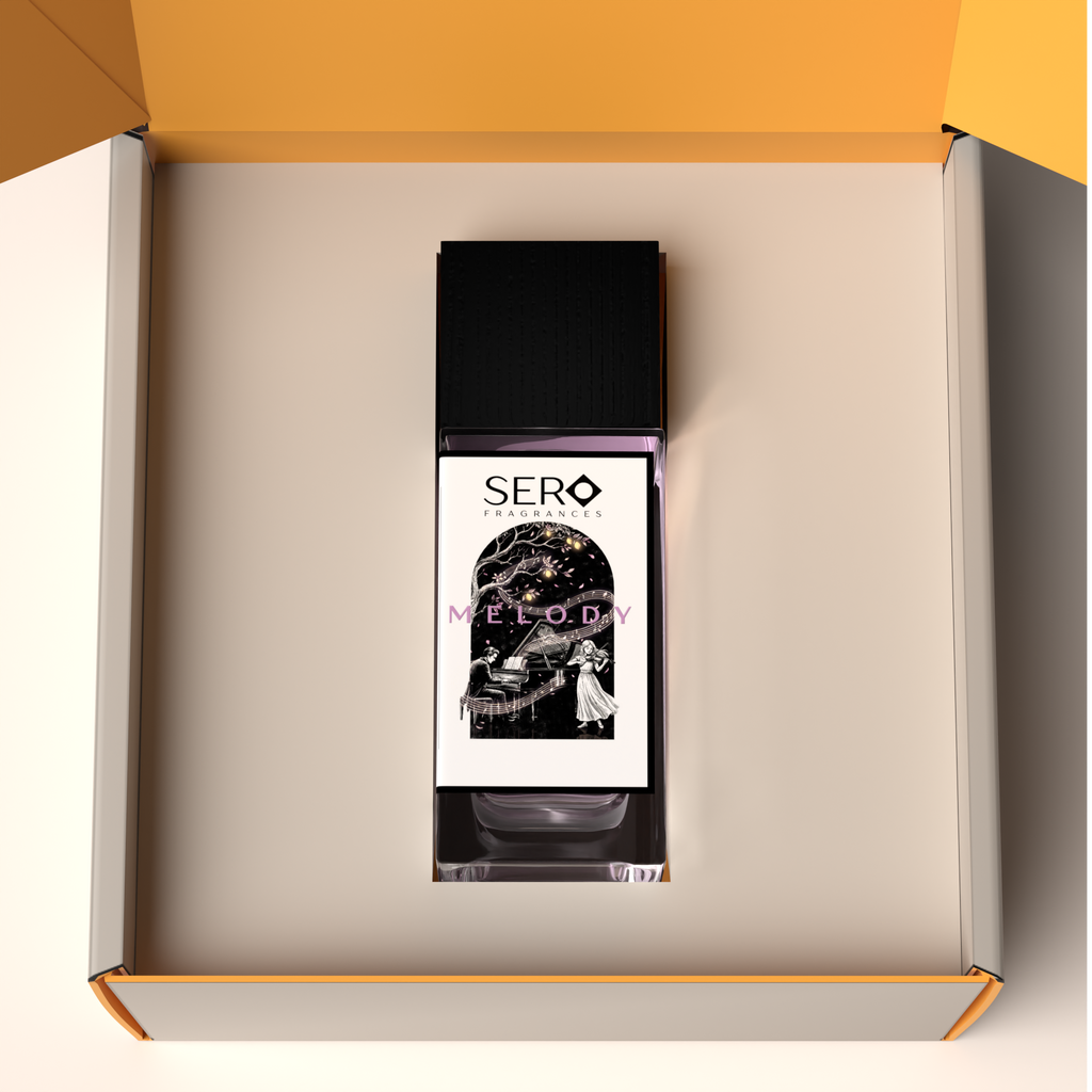 Top view of a packaging within it a minimalist clear glass perfume bottle with black wood cap containing SERO fragrance inspired by LV Symphonie. 