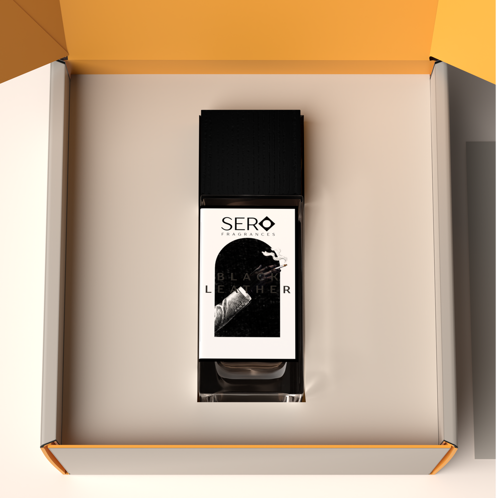 Top view of a packaging within it a minimalist clear glass perfume bottle with black wood cap containing SERO fragrance inspired by TOM FORD's Ombré Leather. 
