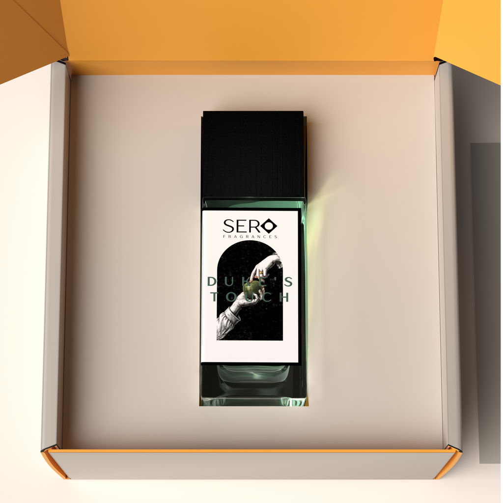 Top view of a packaging within it a minimalist clear glass perfume bottle with black wood cap containing SERO fragrance inspired by Parfums de Marly's Layton. 
