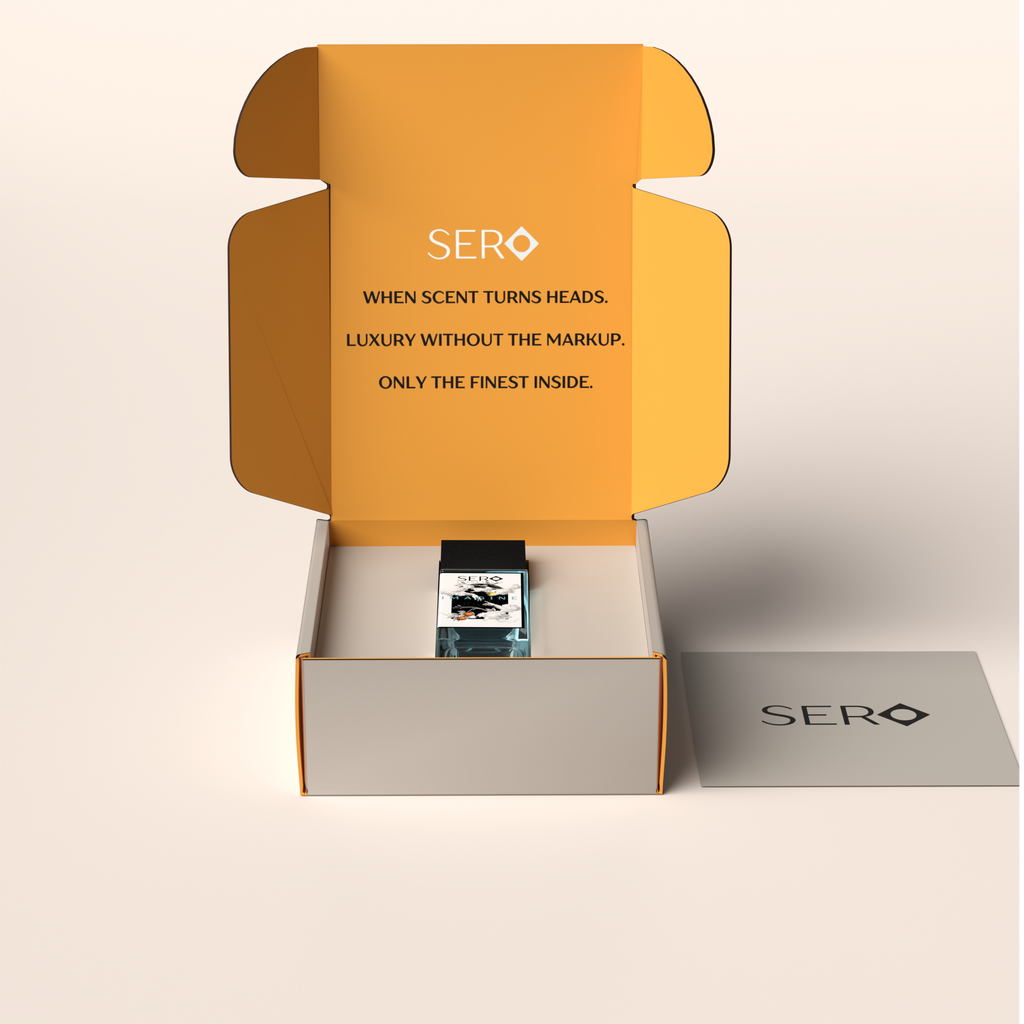 Front view of a packaging within it a minimalist clear glass perfume bottle with black wood cap containing SERO fragrance inspired by LV Imagination.